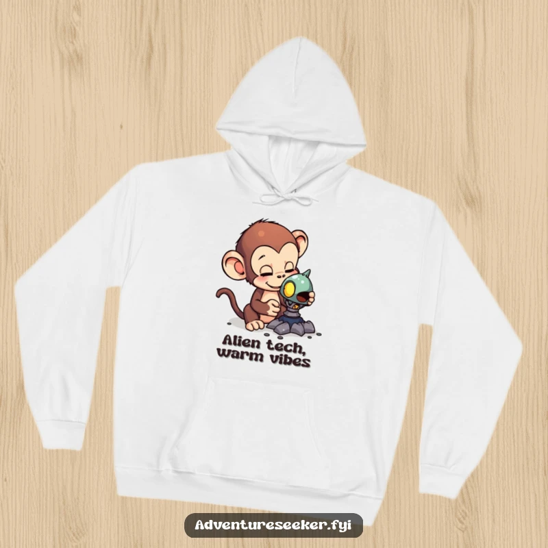 Funny hoodie with a curious monkey examining a strange alien artifact, offering warmth and a humorous touch of interstellar wonder.
