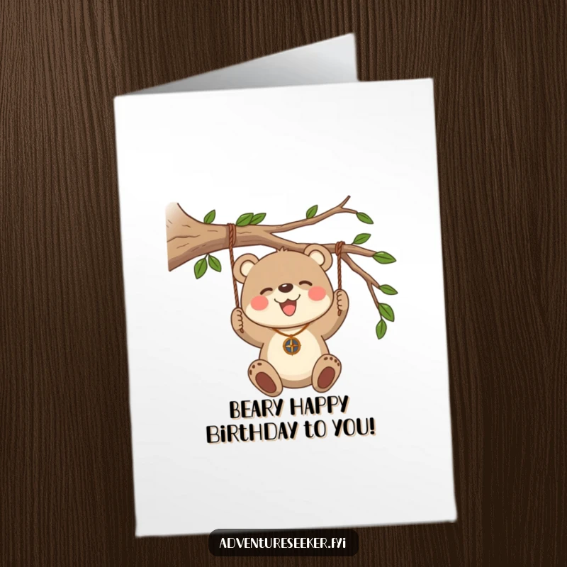 Funny Free Printable Birthday Card: Bear cub with compass necklace swings from a branch, joyful exploration.