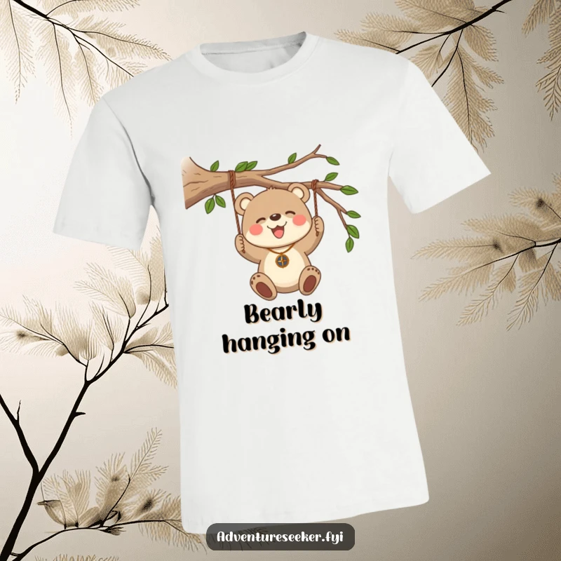 Funny Bear Cub Compass T-Shirt. A joyful bear cub with a compass necklace swings from a sturdy branch.