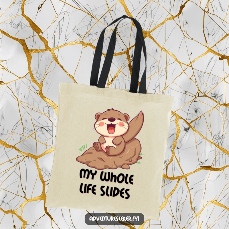 Funny otter tote bag showcasing a giggling character gleefully sliding down a muddy hill, ready for any adventure.
